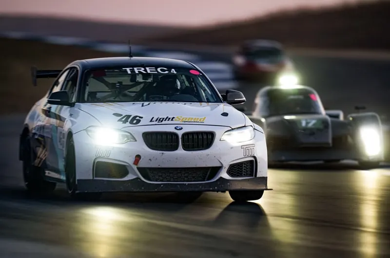 BMW M240iR run by TMR racing into dusk with headlights on